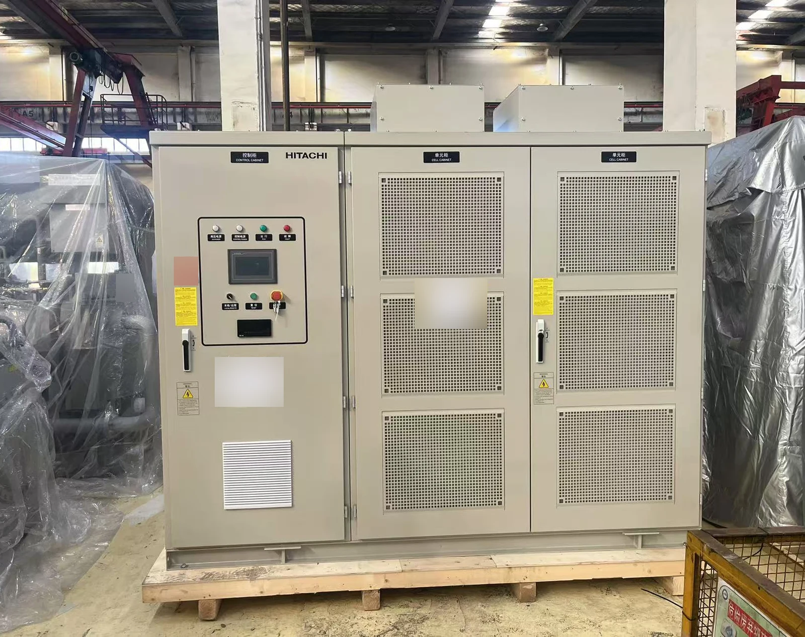 Hitachi chiller control and electrical cabinets on a shipping pallet for Thaixing Circuits